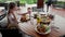 Lonely upset woman sit by table with food in restaurant, wait friend, husband