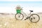 Lonely vintage bicycle on the tropical sandy beach  with No More Plastic bag in the basket with sky and calm sea at background,