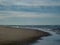 A lonely walker on the beaches of the Ameland island in the Netherlands in Autumn