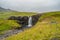 Lonely waterfall called Gufufoss near the road with a sign spelt its name at East Iceland, summer