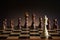 Lonely white chess queen figure on battleground