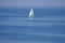 Lonely white sail at infinite ocean