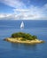 Lonely white sail near island