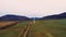 Lonely windmill in the field between Carpathian mountains of Ukraine in spring against a background of cloudy sky