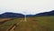 Lonely windmill in the field between carpathian mountains of Ukraine in spring against a background of cloudy sky