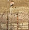 Lonely window in grungy half destroyed wall of a building