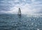 Lonely windsurfer on the sea background