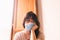Lonely woman at home in breathing medical respiratory mask on her face, bored woman. Chinese pandemic coronavirus, virus covid-19