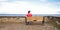 Lonely woman sitting on a bench watching the sea