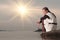 Lonely woman sitting on lake coast