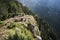 Lonely wooden bench on the edge of a high precipice overlooking the mountain