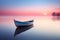 Lonely wooden boat on lake with reflections in water at dawn