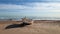 Lonely wooden boat on a sandy beach