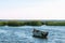 Lonely wooden rowing fishing boat on Lake Drivyaty at sunset. Braslav lakes. Belarus