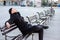 Lonely or worried young man sitting alone on a bench.