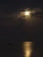 Lonely yacht with lowered sails is illuminated by the moon