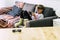 Lonely young caucasian children at home playing with technology videogames portable device with online connected friends - modern