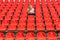 Lonely young woman sitting in armchair at stadium