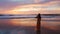 Lonely young woman standing and looking beautiful sky on the tranquil beach at sunset