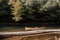 A lonesome canoe tethered to a tree on the river bank