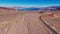 Lonesome road through the desert from above aerial view