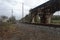 Long abandoned railroad overpass support next to tracks on an overcast day in the deep south