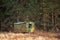 Long ago abandoned trailer forgotten in the woods high contrast autumn landscape with copy space for text advert