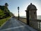 Long alley along the sea with a turret on sunset to  Cadiz in Spain.