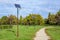 Long alley and a lighting pole activated with an attached blue solar panel in Parcul Izvor Izvor Park in Bucharest, Romania,