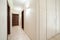 Long anteroom inside bright apartment