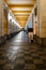 Long arcades tunnel with walking people at night