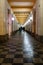 Long arcades tunnel with walking people at night