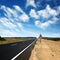 Long asphalt road and blue sky