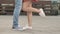 Long-awaited meeting of young loving people. Couple of young lovers kissing outdoors, close-up legs and shoes. Love and