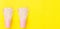 Long Banner Repeating Stacked Pink Drinking Paper Cups with Striped Straws on Yellow Background. Flat Lay Composition. Birthday