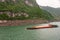 Long barge sailing upriver Yangtze River West of 3 Gorges Dam, Zigui, China