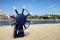 LONG BEACH, CALIFORNIA - 21 FEB 2015: Ships Helm Wheel at Shoreline Aquatic Park with Rainbow Harbor and city skyline in the