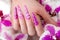 Long beautiful manicure with flowers on female fingers. Nails design. Close-up