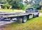 This long bed tow trunk stays busyâ–ª transporting wrecked vehecals Tampa Florida green lawn