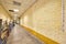 The long beige corridor with brick walls