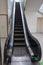 Long Black Escalator on the Move in a Public Space