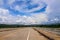 Long blank asphalt road on the bridge  and landscape blue sky with beautiful clouds , mountain view background