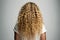 Long Blonde Afro Curls , Rear View On White Background. Generative AI