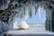 Long blue icicles in the ice cave at coastal cliffs.