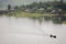 Long boat is floating on river in dam