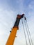 The long boom with the metal sling of the large mobile crane
