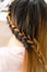 Long braid creative brown hair style in salon