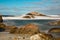 Long camera exposure of ocean waves against rocky coast