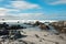 Long camera exposure of ocean waves against rocky coast