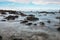 Long camera exposure of ocean waves against rocky coast